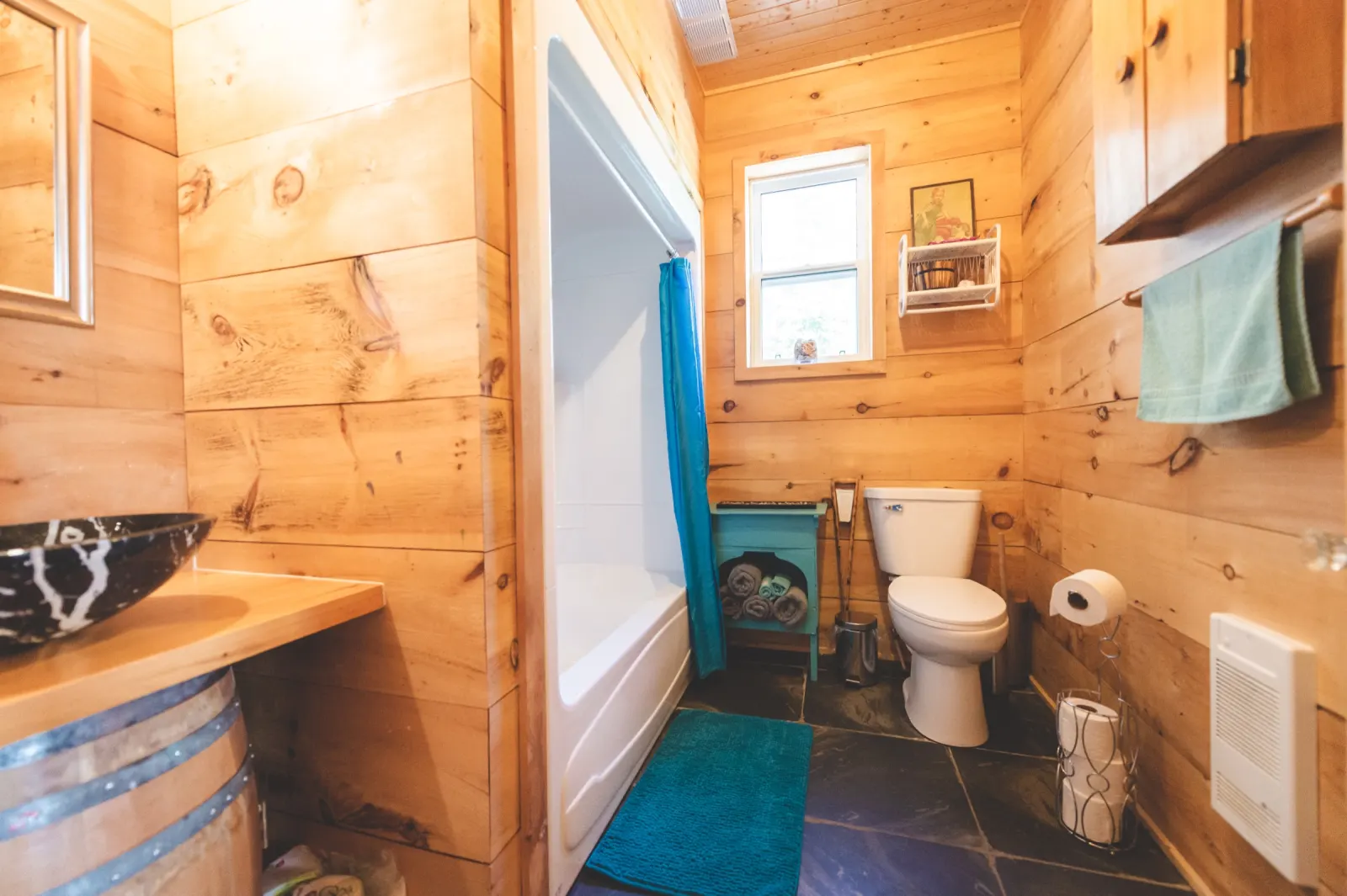 The pine bathroom with a bathtub