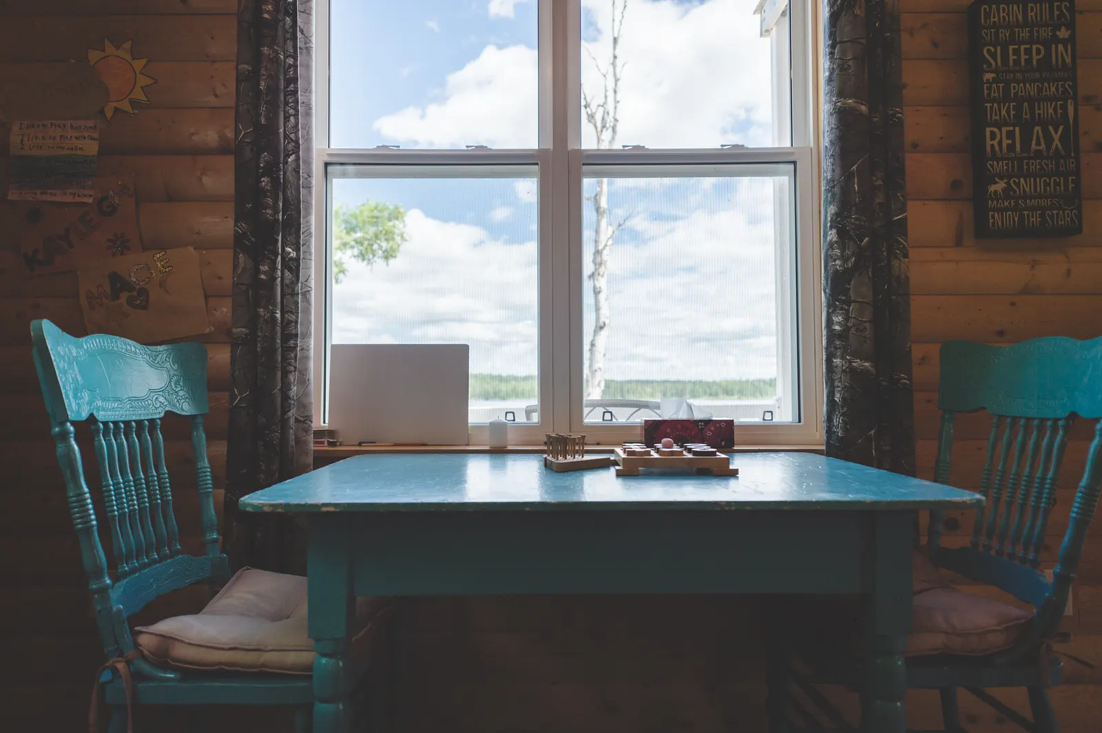 A table by the window, looking out to the trees and pond