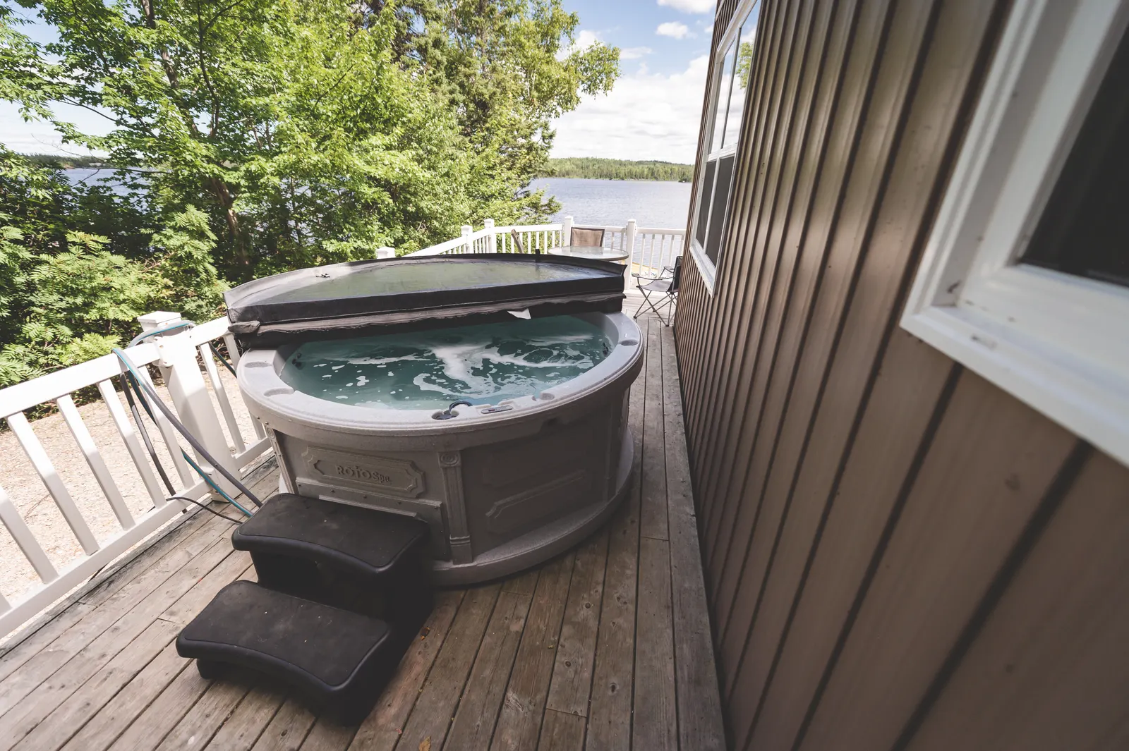 The private hot tub on the deck, with the pond beyond