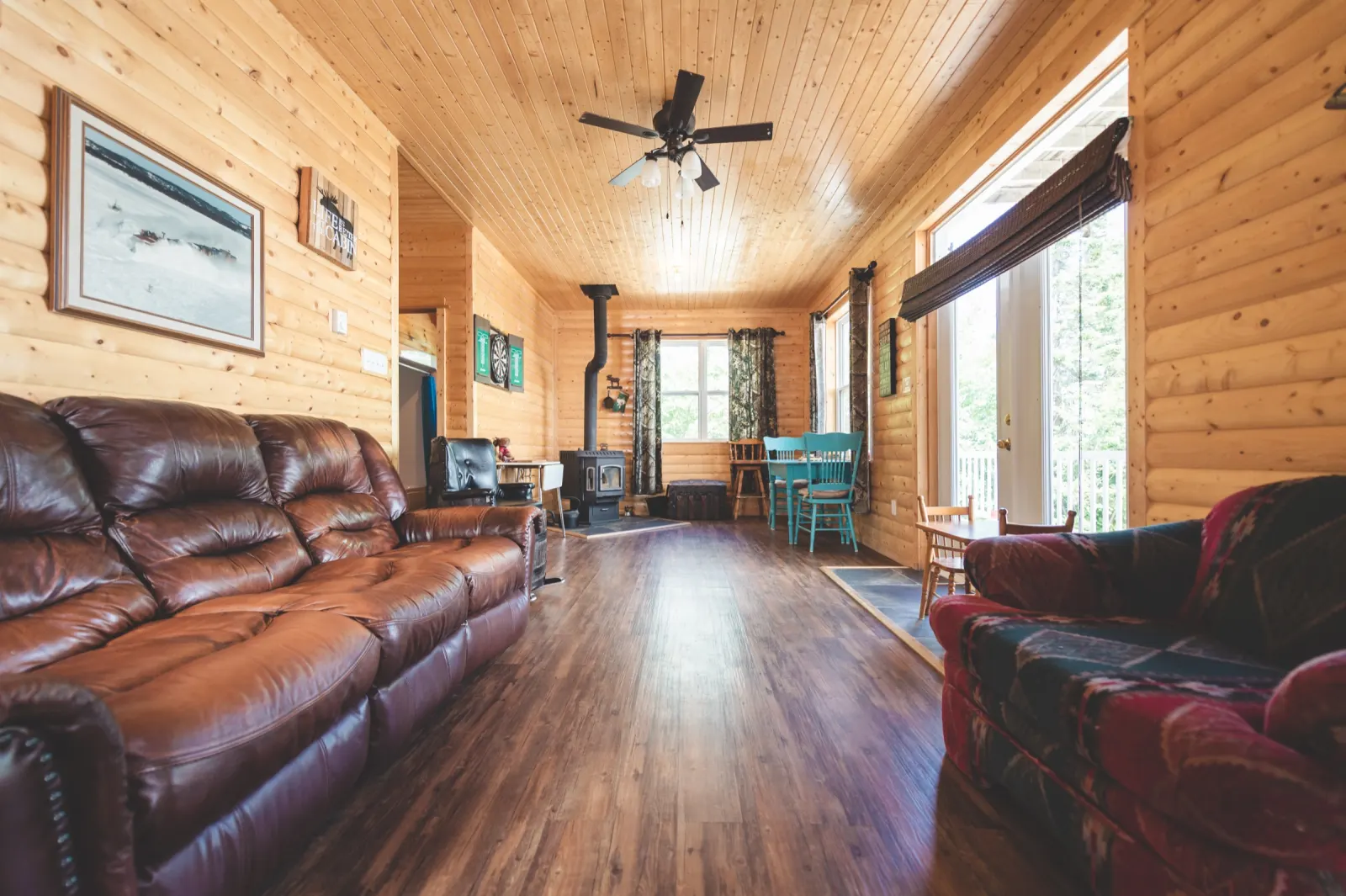 The pine-panelled living room with leather sofas