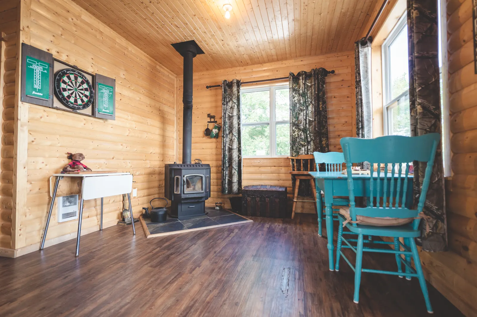 The wood stove, a dartboard and the dining table